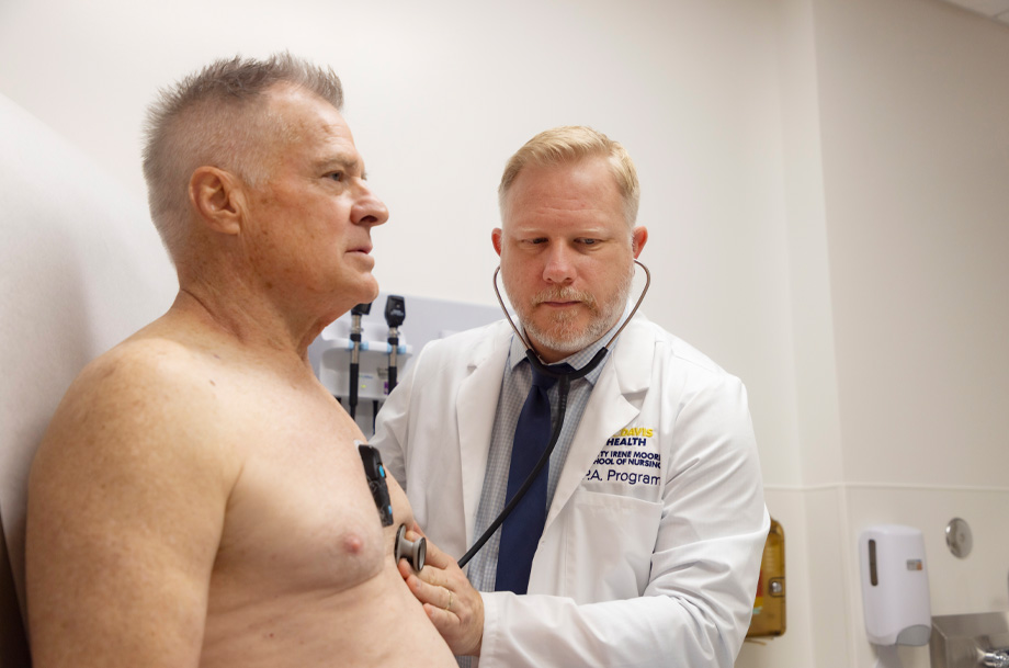 Nick Woods uses stethoscope to listen to Mitch Darnell&rsquo;s heart