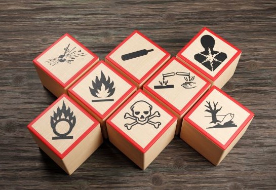 Wooden blocks show symbols for types of chemicals and other hazards.