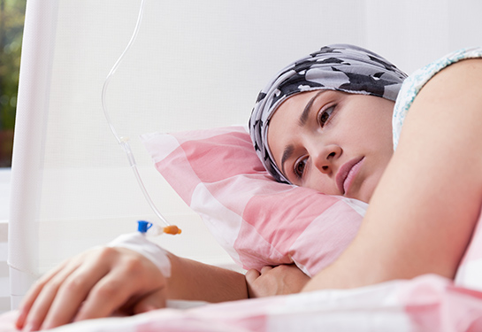 Photo of young pretty cancer girl lying in hospital